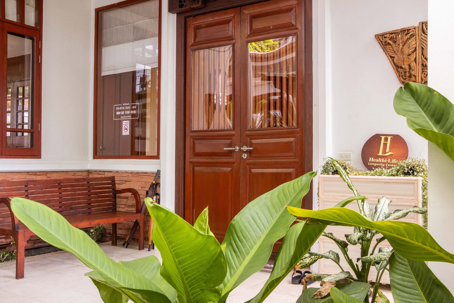Healthi Life — wooden entrance of the Thai house in Ekkamai, Bangkok